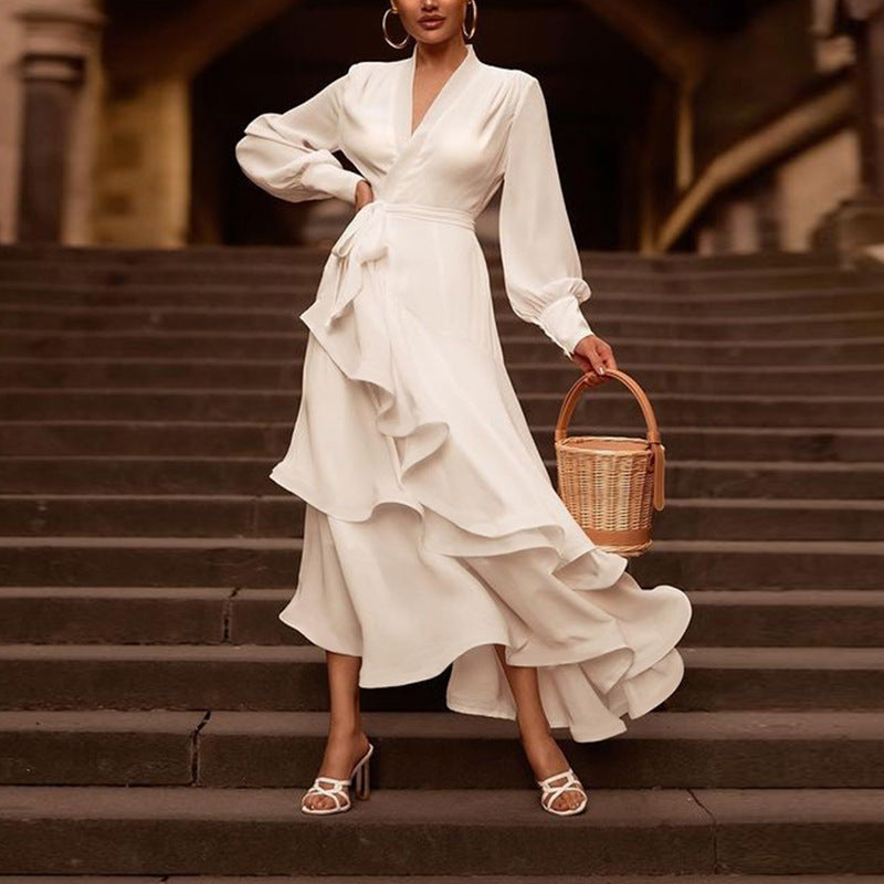 Chic satin white gown with flounced layered skirt and bishop sleeves, perfect for formal occasions and evening wear.
