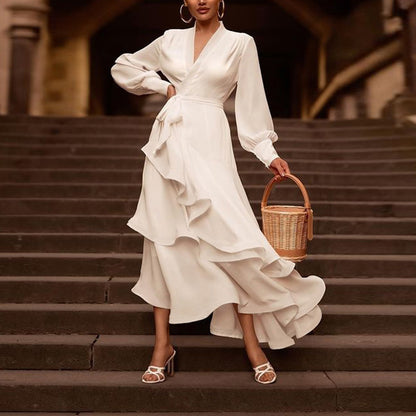 Chic satin white gown with flounced layered skirt and bishop sleeves, perfect for formal occasions and evening wear.